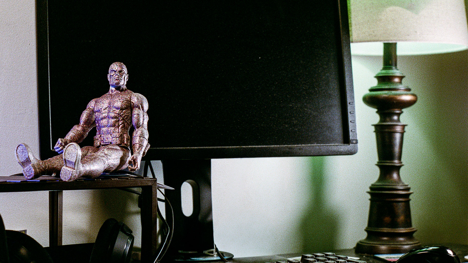 Action hero on computer desk.